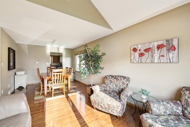 living room with hardwood / wood-style floors and vaulted ceiling