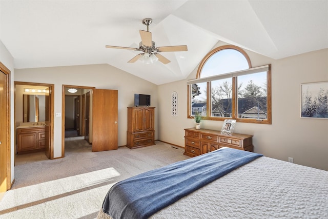 bedroom with light carpet, ceiling fan, ensuite bath, and lofted ceiling