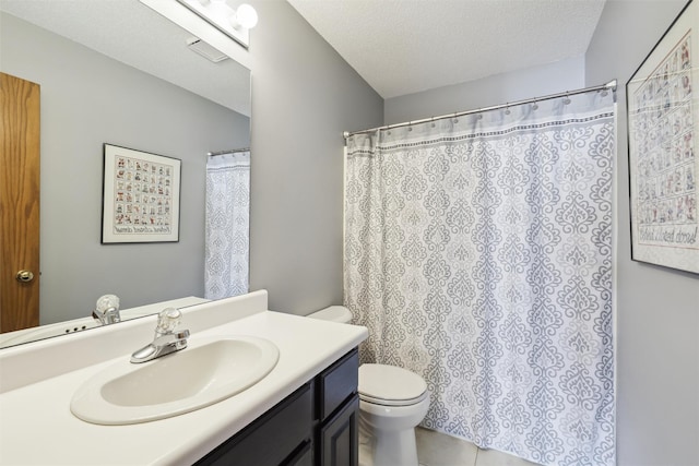 bathroom featuring vanity, tile patterned flooring, a textured ceiling, curtained shower, and toilet