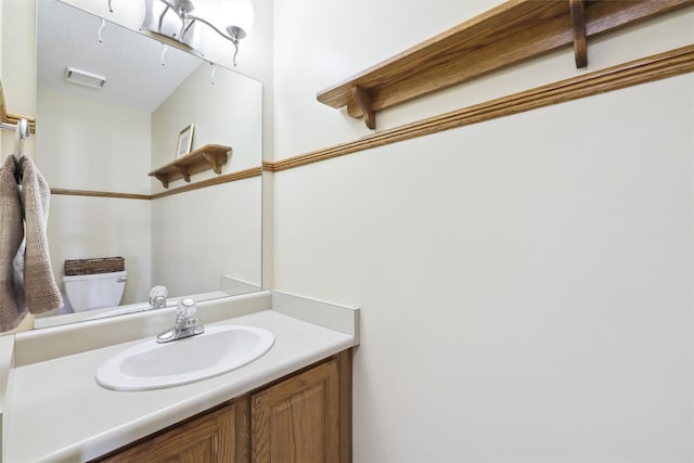 bathroom with vanity and toilet