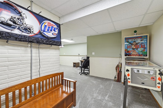 bedroom with a drop ceiling, carpet floors, and wainscoting