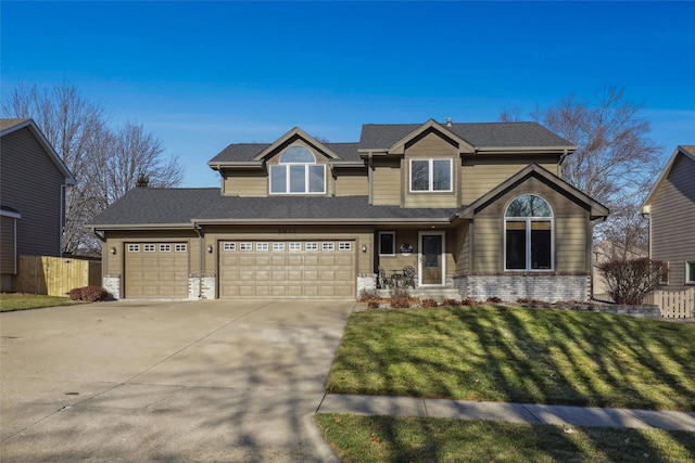 craftsman inspired home with brick siding, fence, driveway, roof with shingles, and a front yard