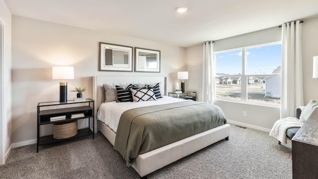 carpeted bedroom with visible vents and baseboards