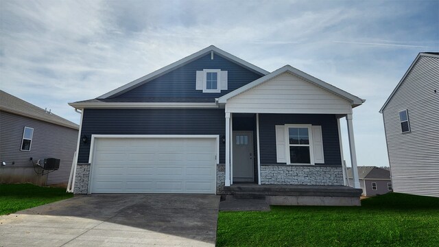 view of front of home featuring stone siding, covered porch, driveway, and an attached garage