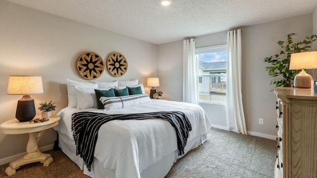 bedroom with baseboards, a textured ceiling, and light colored carpet