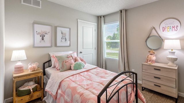 carpeted bedroom featuring a textured ceiling, visible vents, and baseboards