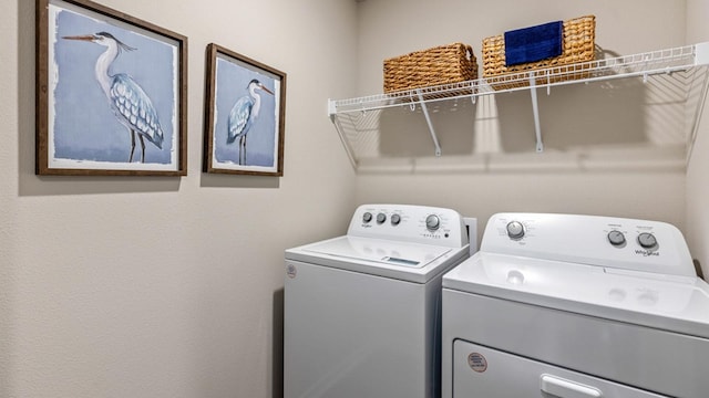 washroom featuring laundry area and washer and dryer