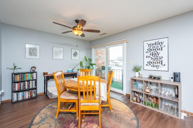 dining area with visible vents, wood finished floors, baseboards, and ceiling fan