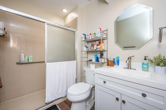 full bathroom with toilet, wood finished floors, an enclosed shower, and vanity