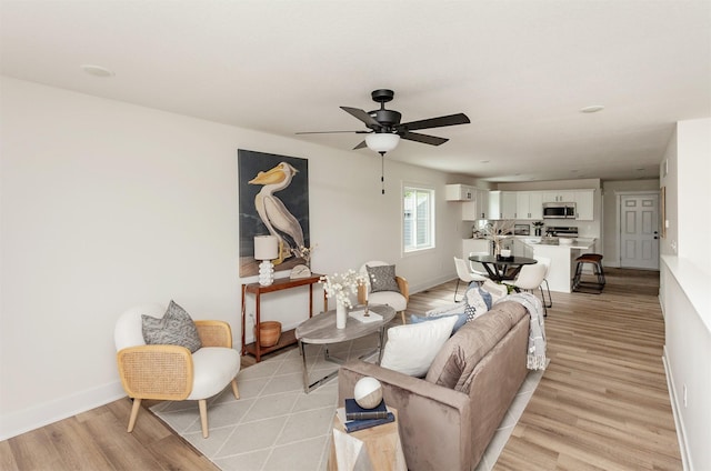2503 Shaw St, Des Moines, IA 50317 - living area with light wood-type flooring, baseboards, and ceiling fan