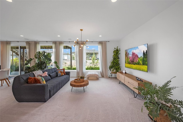 carpeted living room with a notable chandelier