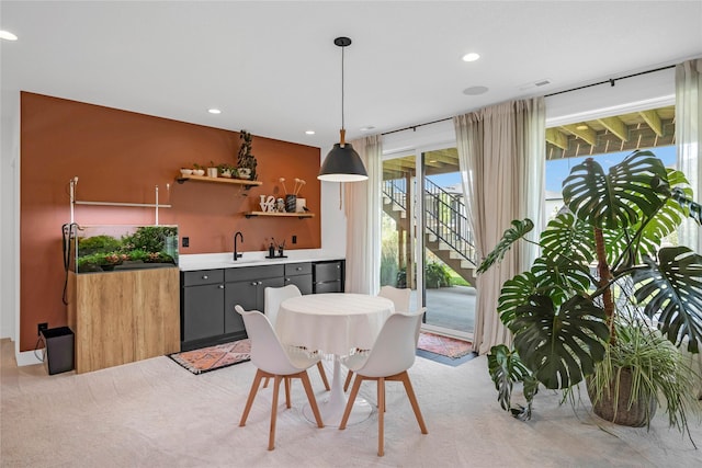 carpeted dining room featuring indoor wet bar