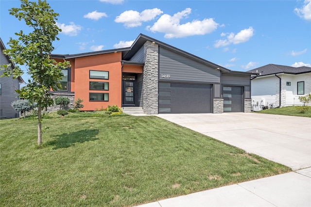 contemporary house featuring a front yard and a garage