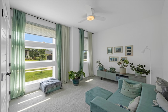 sitting room with carpet flooring and ceiling fan