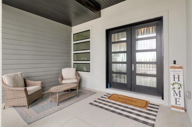 entrance to property with french doors and a porch