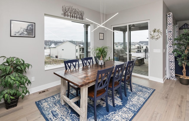 dining area featuring light hardwood / wood-style floors and a notable chandelier