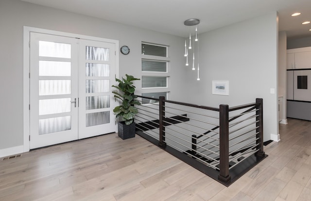 interior space with french doors and light hardwood / wood-style floors