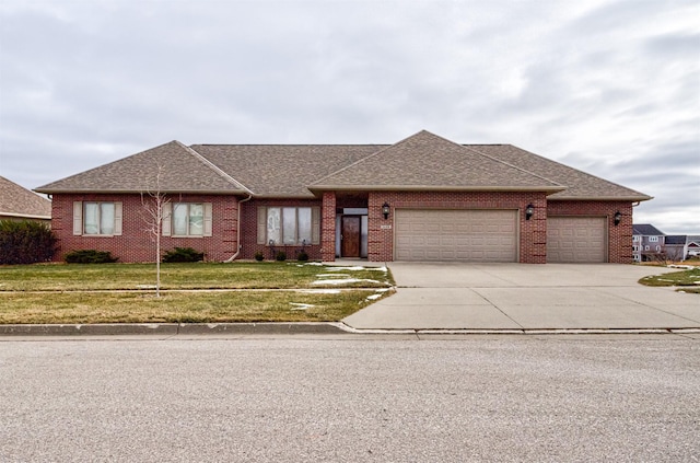 view of front of property featuring a front yard and a garage