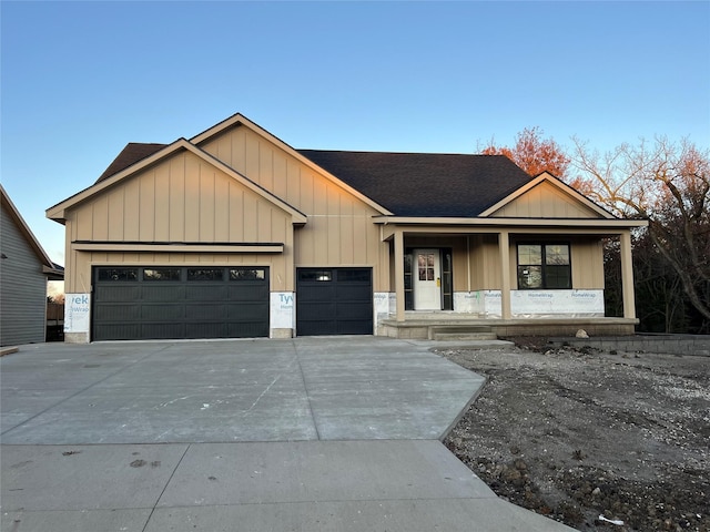 view of front facade featuring a porch and a garage