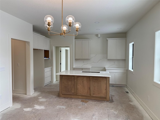 kitchen with a center island, hanging light fixtures, and white cabinets