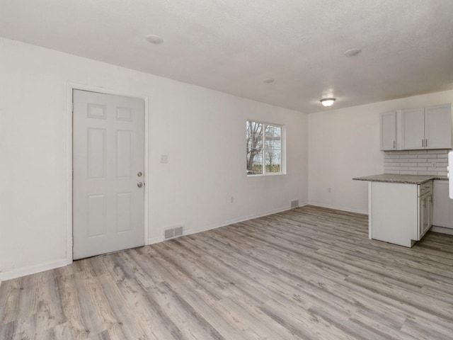 unfurnished living room featuring light hardwood / wood-style flooring