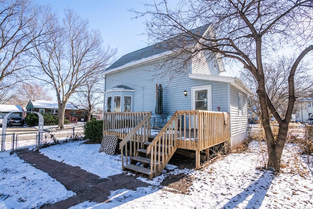 snow covered property featuring a wooden deck