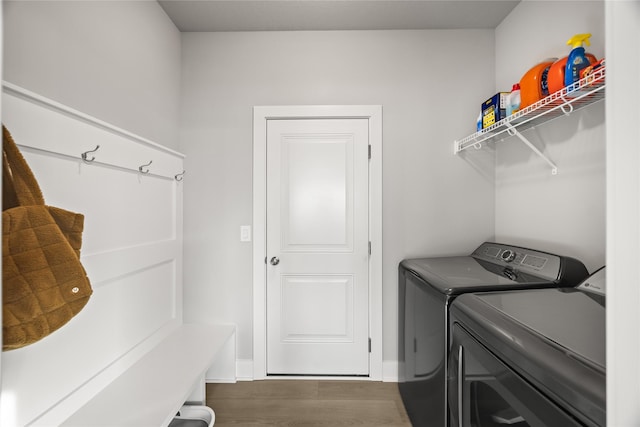 laundry area with dark wood-type flooring and washing machine and clothes dryer