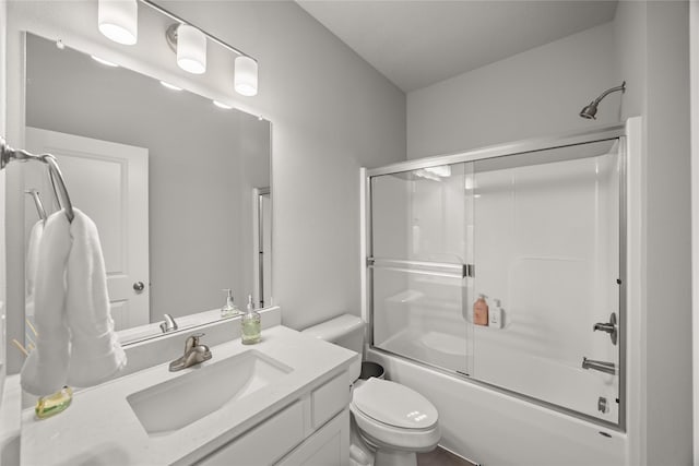 full bathroom with vanity, toilet, and bath / shower combo with glass door