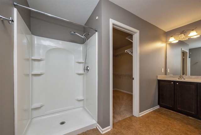 bathroom with a shower and vanity