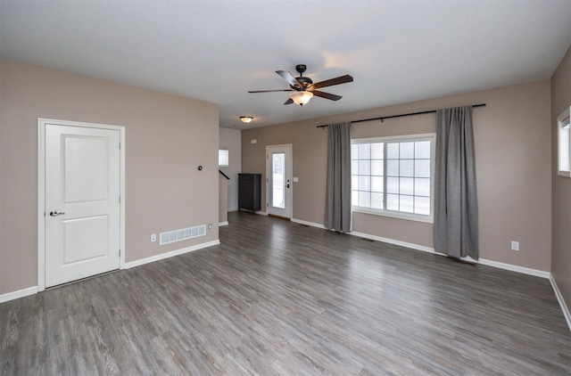 unfurnished living room with ceiling fan and dark hardwood / wood-style flooring