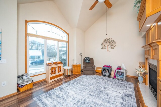 recreation room featuring dark hardwood / wood-style floors, vaulted ceiling, and ceiling fan