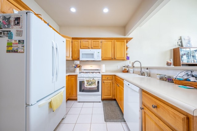 kitchen with sink, light tile patterned floors, and white appliances