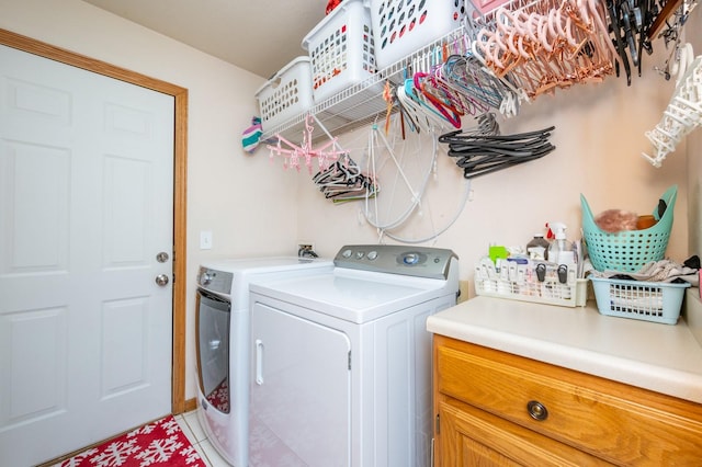 laundry room with washer and dryer and tile patterned flooring