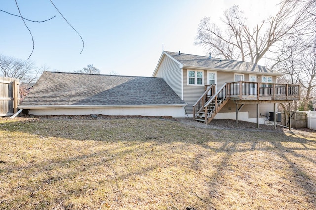 back of house featuring fence, stairway, a yard, roof with shingles, and a wooden deck