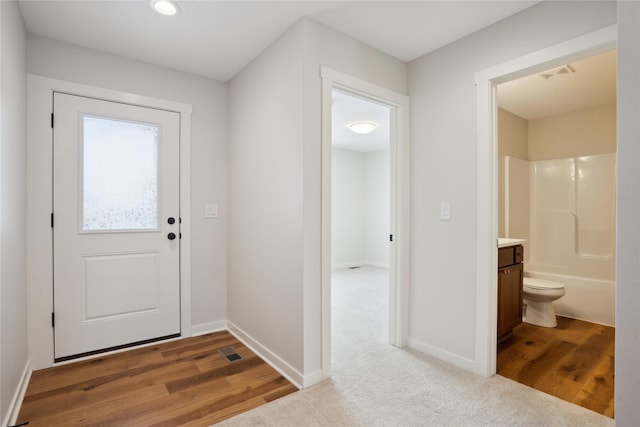 doorway with carpet flooring