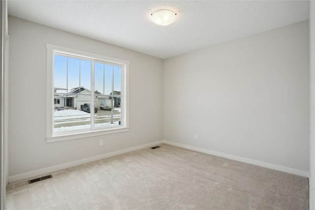 empty room featuring light carpet