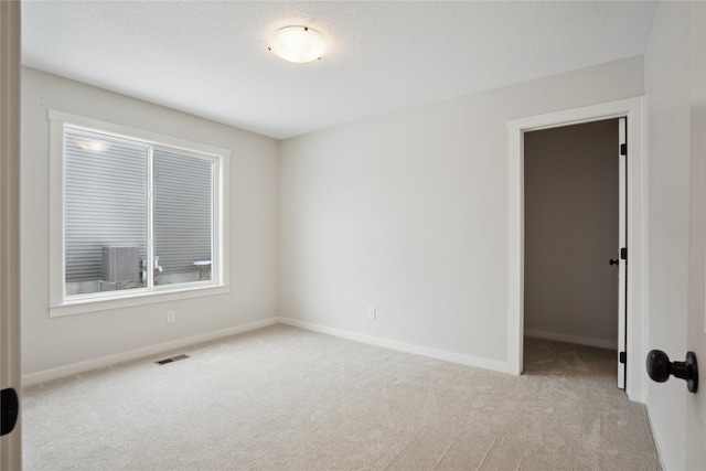 unfurnished room with light carpet