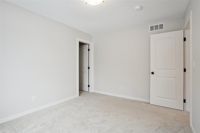 empty room featuring light carpet