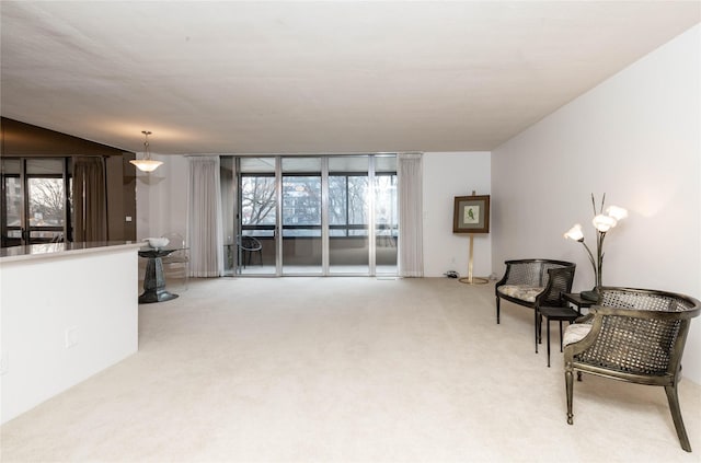 living area with light carpet and expansive windows