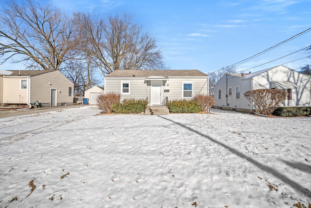 view of snow covered back of property