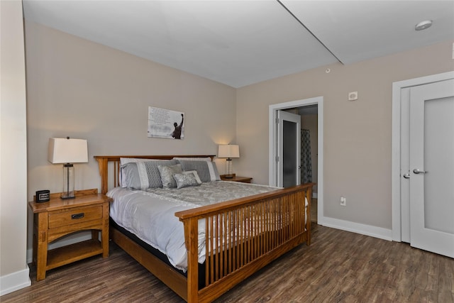 bedroom with baseboards and wood finished floors