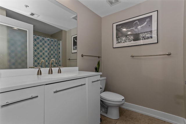 full bathroom featuring toilet, vanity, baseboards, visible vents, and tile patterned floors