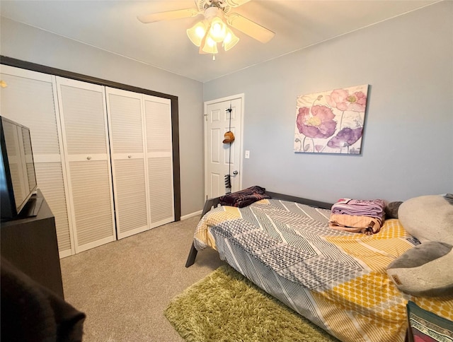 carpeted bedroom with ceiling fan and a closet