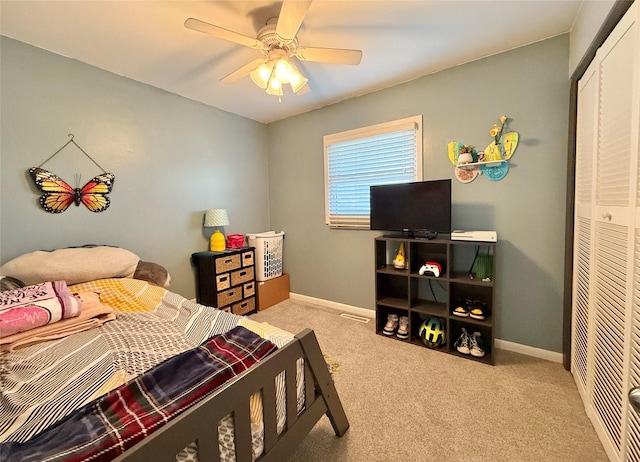 bedroom featuring light carpet, a closet, and ceiling fan