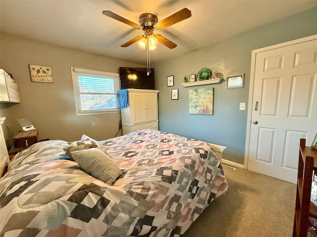 bedroom featuring ceiling fan and carpet