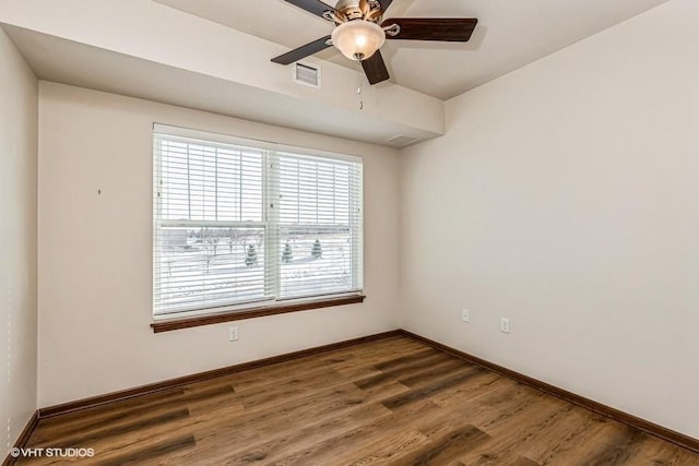 spare room with dark hardwood / wood-style floors and ceiling fan