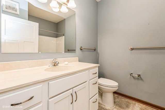 bathroom with vanity, toilet, and walk in shower