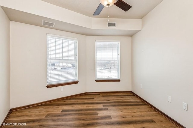 spare room featuring dark hardwood / wood-style floors and ceiling fan