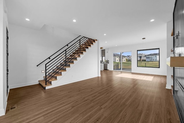 unfurnished living room with dark hardwood / wood-style flooring