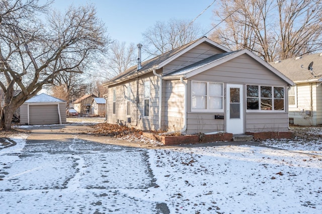 view of front of house with a garage and an outdoor structure